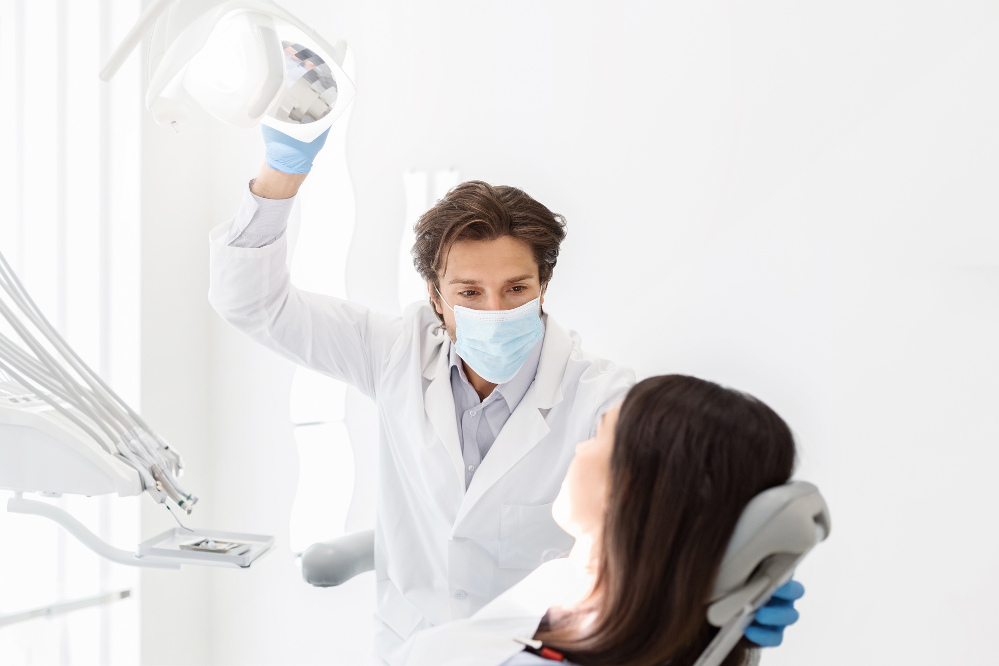 attentive-dentist-listening-to-female-patient-in-cabinet.jpg